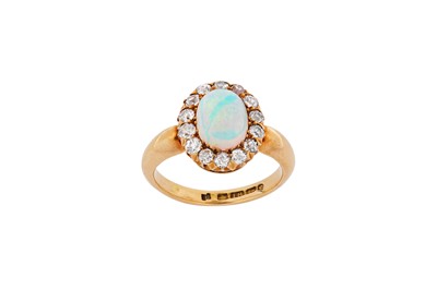 Lot 18 - An opal and diamond cluster ring, 1902 The...