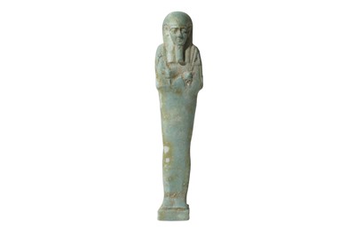 Lot 9 - A GLAZED COMPOSITION SHABTI A pale blue glazed...