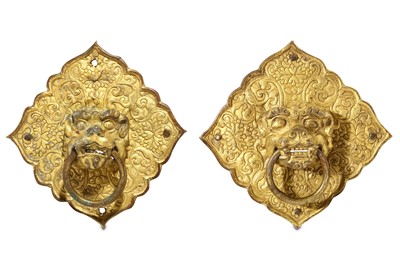 Lot 368 - TWO GILT METAL HANDLES. Formed as lion heads...