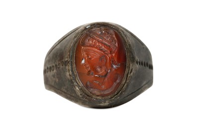 Lot 53 - A LARGE PERSIAN SILVER RING WITH CARNELIAN...