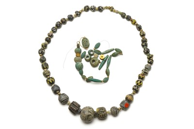 Lot 27 - TWO GLASS AND FAIENCE BEAD NECKLACES Roman -...