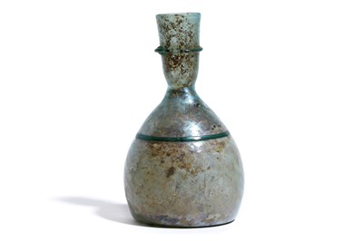 Lot 170 - A ROMAN GREEN GLASS FLASK Circa 3rd Century...