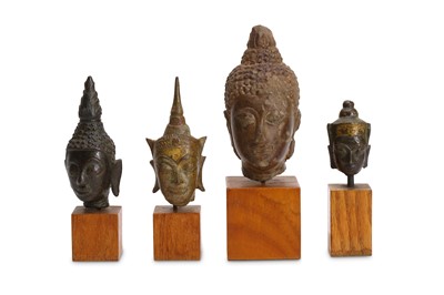 Lot 410 - FOUR BRONZE BUDDHA HEADS Cambodia and Laos,...