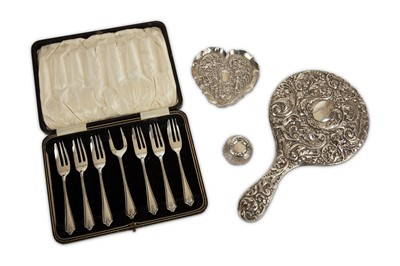 Lot 233 - An Edwardian embossed silver hand mirror,...