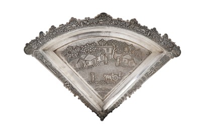 Lot 328 - AN INDIAN REPOUSSÉ FAN-SHAPED SILVER TRAY...