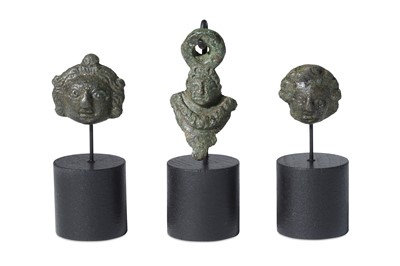 Lot 115 - THREE ROMAN BRONZE APPLIQUES Roman Period and...