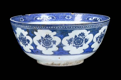 Lot 227 - A LARGE QAJAR BLUE AND WHITE POTTERY BOWL Iran,...