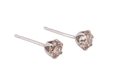 Lot 632 - A pair of diamond ear studs, each claw-set...