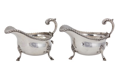 Lot 67 - A pair of George V sterling silver sauceboats,...