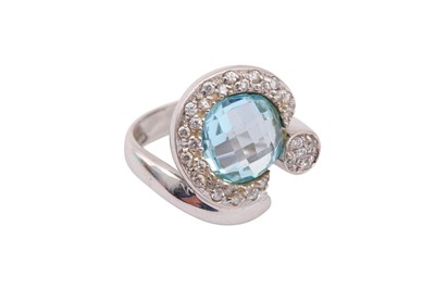 Lot 642 - A blue topaz and diamond ring, the circular...