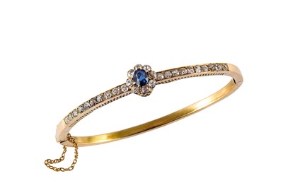 Lot 91 - A sapphire and diamond bangle Of hinged form,...