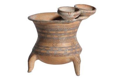 Lot 33 - A NEAR EASTERN POTTERY THREE-FOOTED VESSEL...