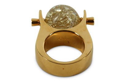 Lot 88 - Chloe Glass Ball Ring, gilt metal mount with...