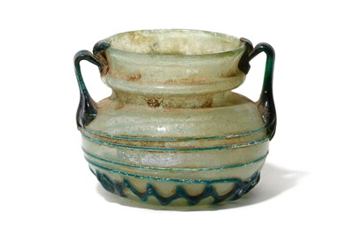 Lot 166 - A ROMAN PALE BLUE GLASS VESSEL Circa 4th...