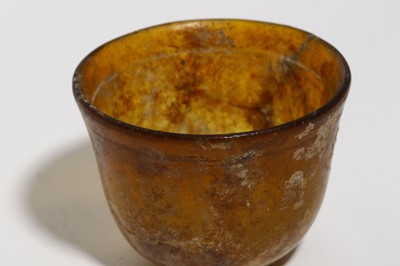 Lot 161 - A ROMAN AMBER GLASS BEAKER Circa 1st - 2nd...