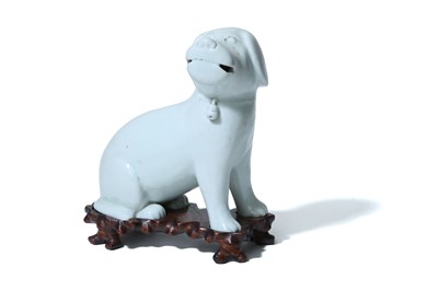 Lot 30 - A WHITE-GLAZED FIGURE OF A DOG. 19th Century....