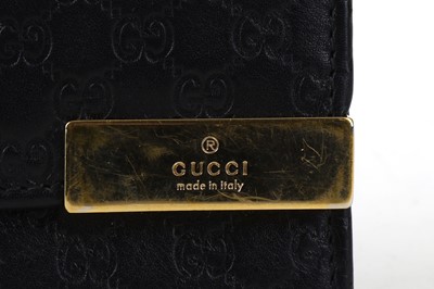 Lot 134 - Gucci Black Guccissima Wallet, embossed logo...