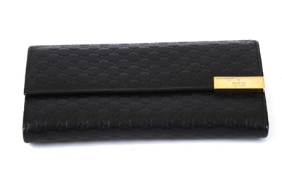 Lot 134 - Gucci Black Guccissima Wallet, embossed logo...