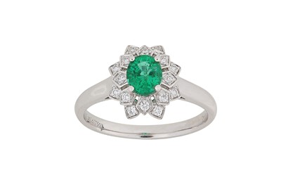 Lot 274 - An emerald and diamond ring The oval-cut...