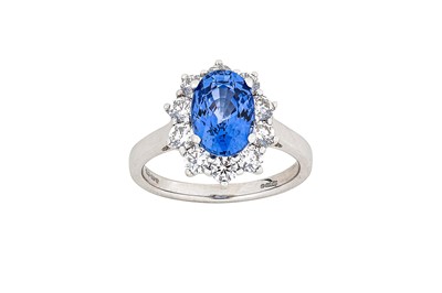 Lot 307 - A sapphire and diamond ring The oval-cut...