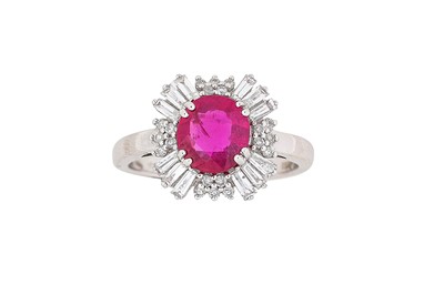 Lot 290 - A ruby and diamond ring The cushion-shaped...