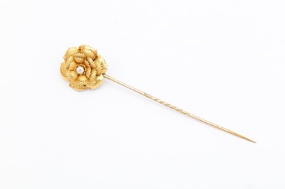 Lot 1 - A diamond flower stickpin, Centrally set with...