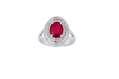 Lot 61 - A ruby and diamond ring The oval-cut ruby in a...