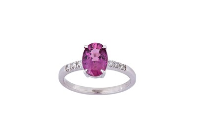 Lot 210 - A purple sapphire and diamond ring The...