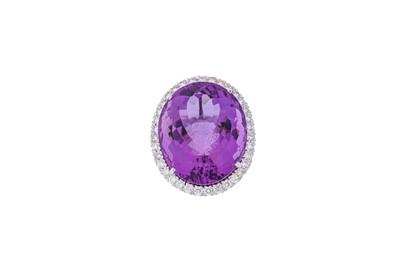 Lot 264 - An amethyst and diamond cluster ring  The oval-...