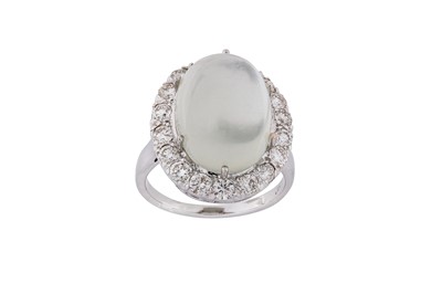 Lot 121 - A moonstone and diamond cluster ring The oval...