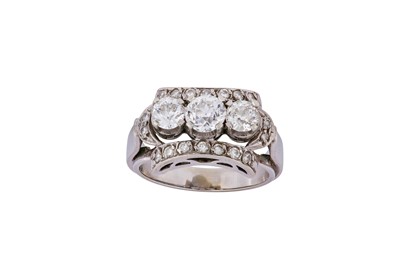 Lot 246 - A diamond three-stone dress ring Centred by a...