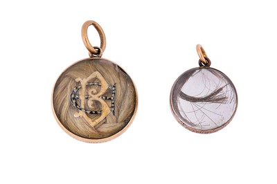 Lot 12 - Two rock crystal and enamel mourning lockets,...