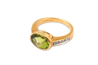 Lot 59 - A peridot and diamond ring, collet-set with an...