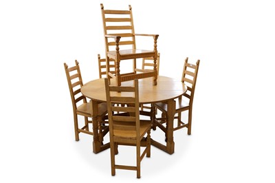 Lot 479 - A honey oak oval drop leaf gateleg dining...