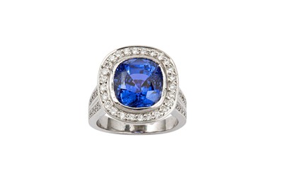 Lot 120 - A sapphire and diamond ring The cushion-shaped...