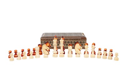 Lot 75 - An ivory chess set, one half stained red/brown,...