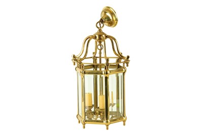 Lot 128 - A brass hanging lantern with bevelled glass.