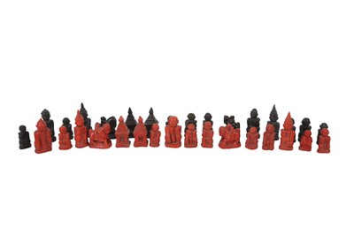 Lot 73 - A Southeast Asian carved and painted chess set,...