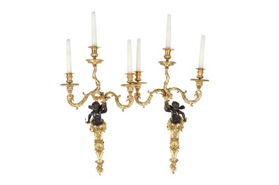 Lot 563 - A LARGE PAIR OF LOUIS XVI STYLE GILT AND PATINATED BRONZE WALL APPLIQUES
