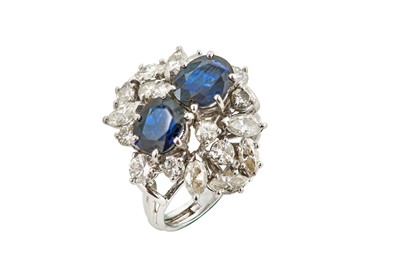 Lot 156 - A sapphire and diamond dress ring The two oval-...