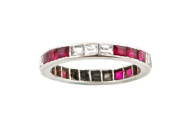 Lot 54 - A ruby and diamond eternity ring Channel-set...