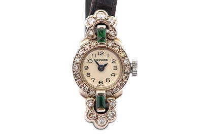 Lot 53 - A diamond and green gem wristwatch, to a black...
